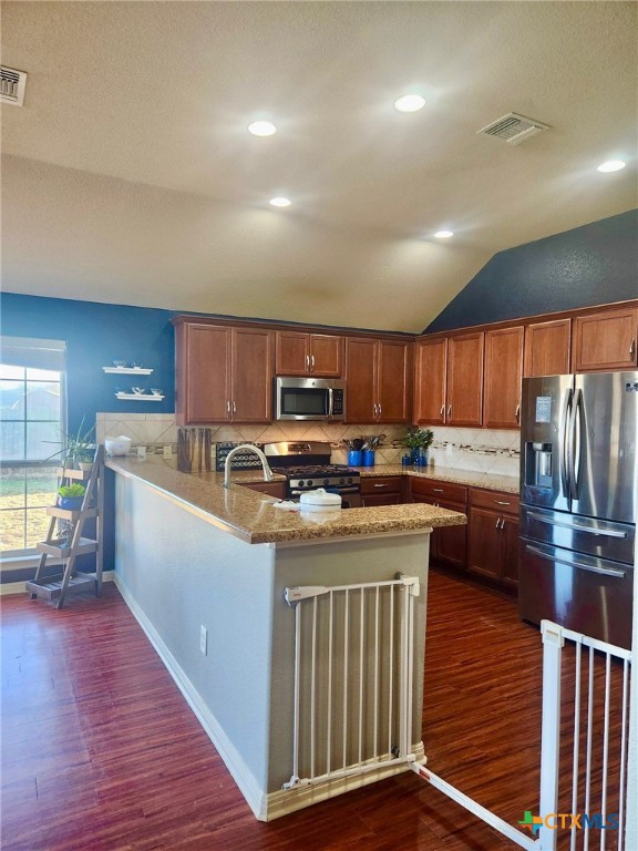 91 Skyview Terrace Leander, TX 78641 - Photo 12 of 25 a kitchen with kitchen island granite countertop a stove and a refrigerator