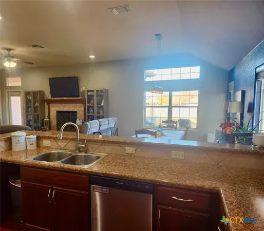 a kitchen with sink cabinets and a wooden floor