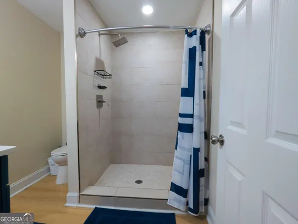 a bathroom with a shower and toilet