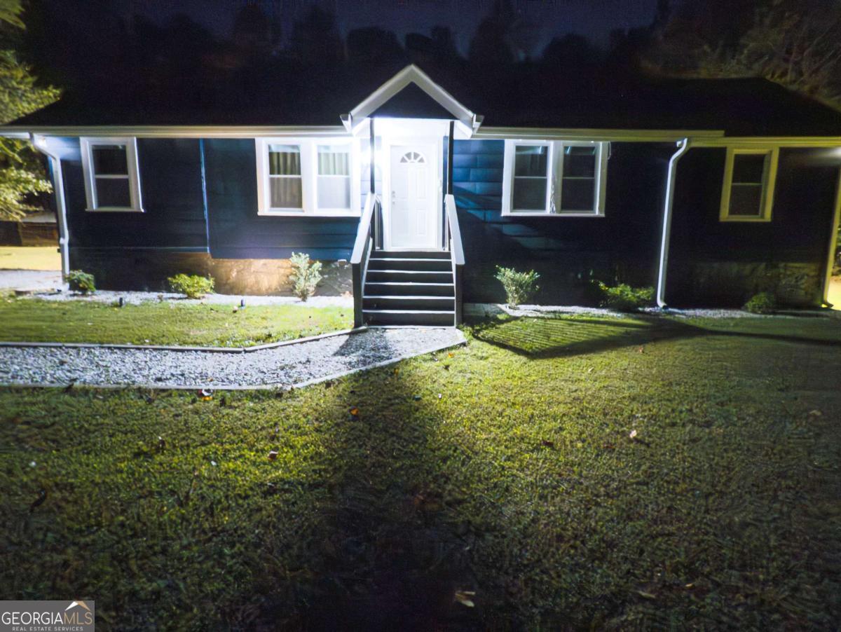 6557 Woodrow Road Lithonia, GA 30038 - Photo 17 of 17 a front view of a house with garden