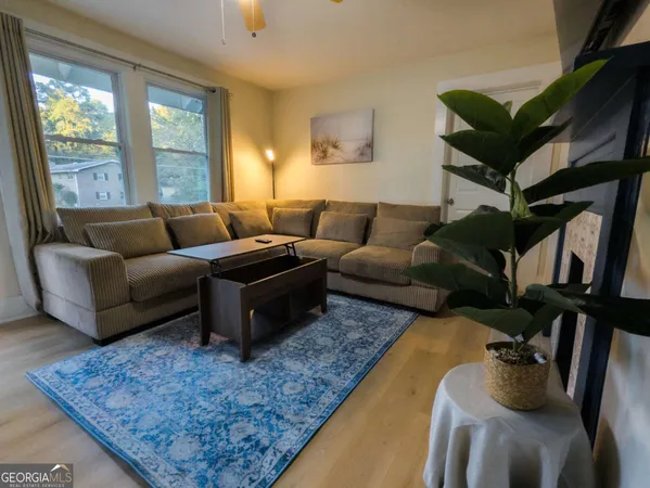 a living room with furniture fireplace and a window