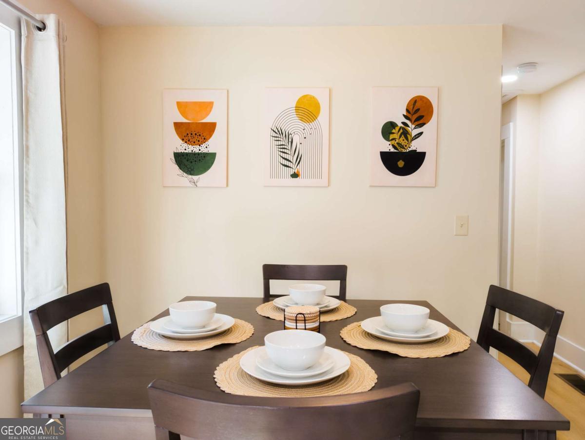 6557 Woodrow Road Lithonia, GA 30038 - Photo 6 of 17 a table and a couple of flower pot