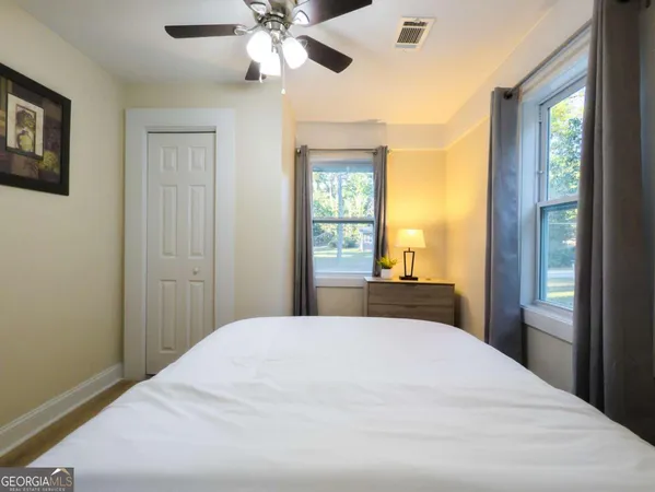 a bedroom with a large bed and a chandelier