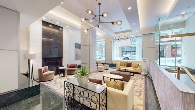 a view of a hallway with wooden floor and windows