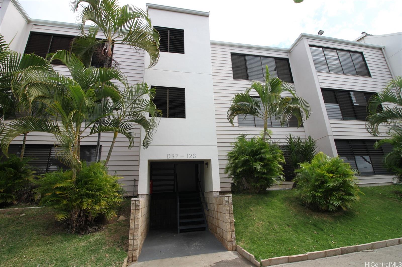 87-126 Helelua Street, Unit D204 Waianae, HI 96792 - Photo 1 of 13 a front view of a house with a garden