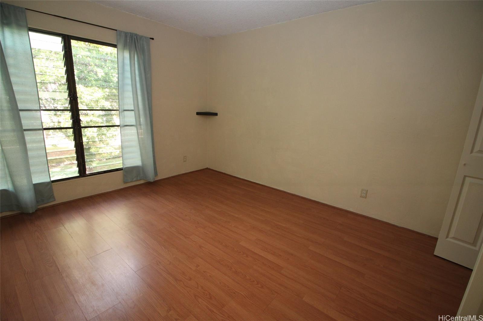 87-126 Helelua Street, Unit D204 Waianae, HI 96792 - Photo 12 of 13 an empty room with wooden floor and windows