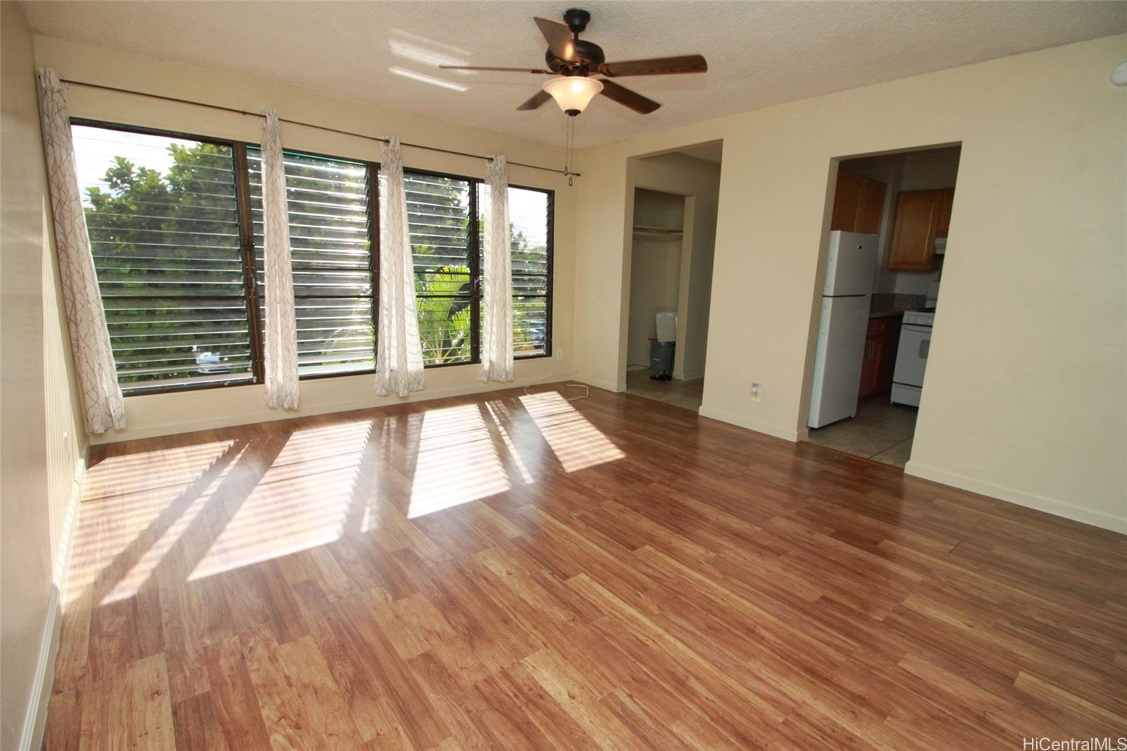 87-126 Helelua Street, Unit D204 Waianae, HI 96792 - Photo 4 of 13 a view of an empty room with wooden floor and a window