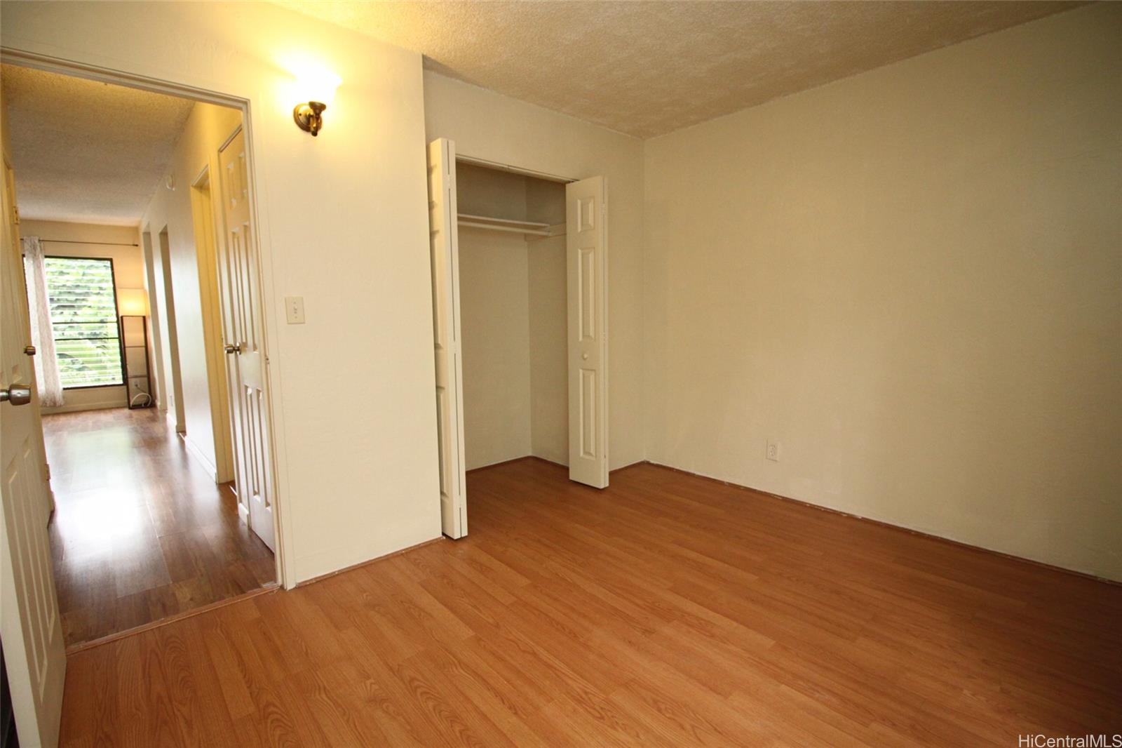 87-126 Helelua Street, Unit D204 Waianae, HI 96792 - Photo 8 of 13 a view of a hallway with wooden floor
