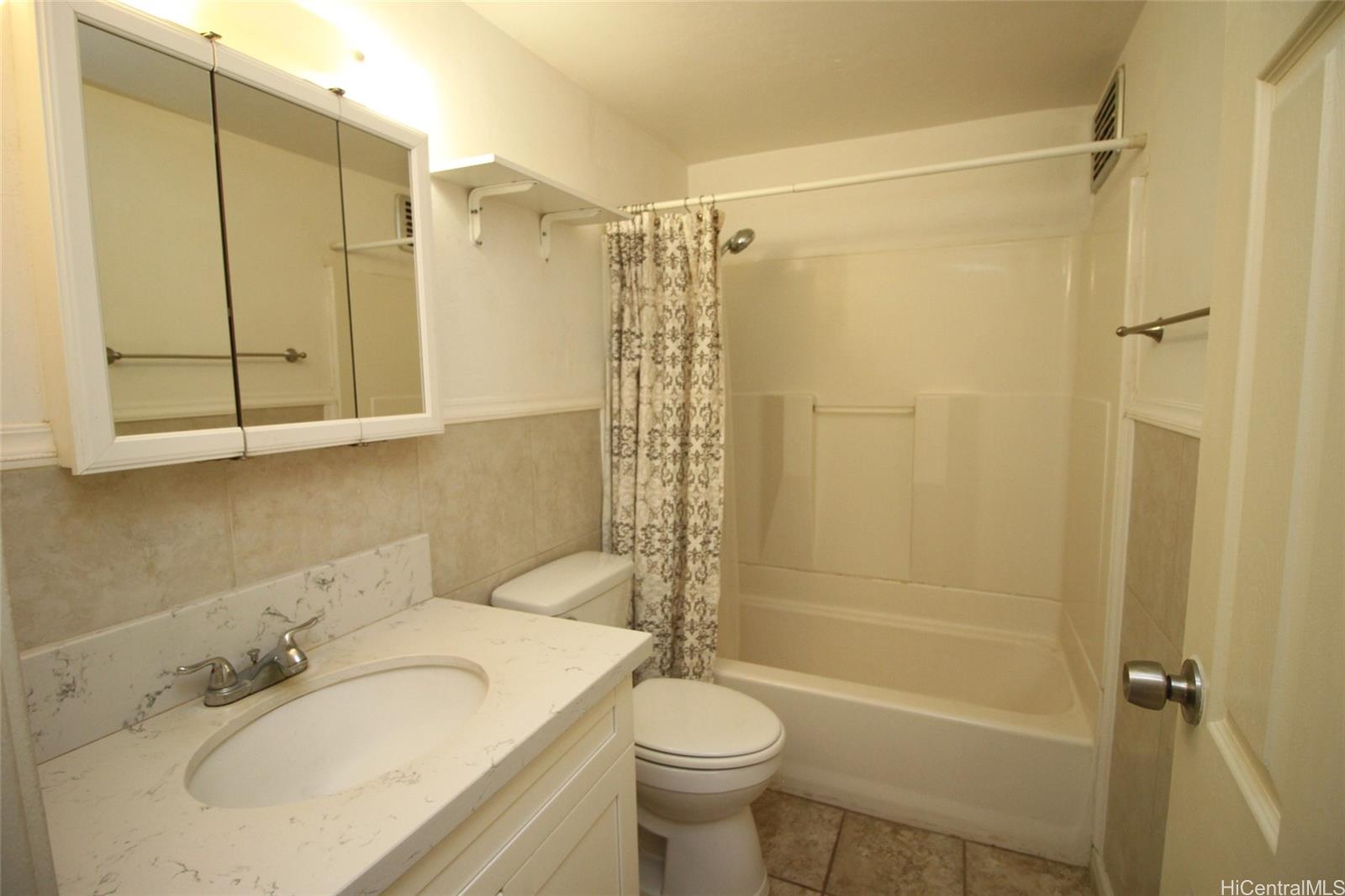 87-126 Helelua Street, Unit D204 Waianae, HI 96792 - Photo 10 of 13 a bathroom with a sink toilet and shower