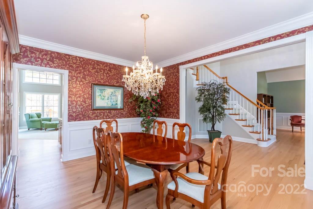 1629 Stevens Ridge Road Matthews, NC 28105 - Photo 14 of 39 a view of a dining room with furniture and chandelier
