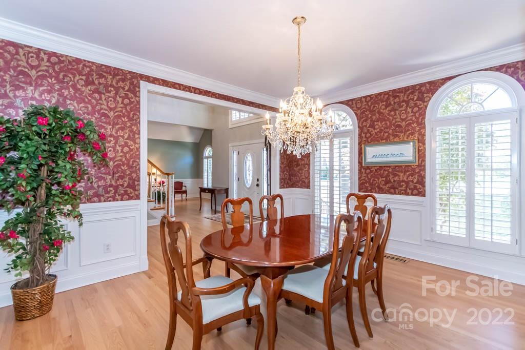 1629 Stevens Ridge Road Matthews, NC 28105 - Photo 15 of 39 a view of a dining room with furniture and chandelier