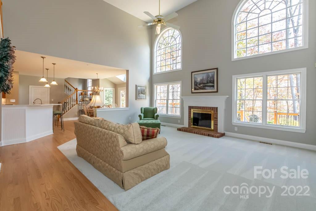 1629 Stevens Ridge Road Matthews, NC 28105 - Photo 17 of 39 a living room with furniture a large window and a fireplace