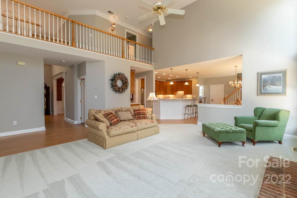 1629 Stevens Ridge Road Matthews, NC 28105 - Photo 18 of 39 a living room with furniture and a chandelier