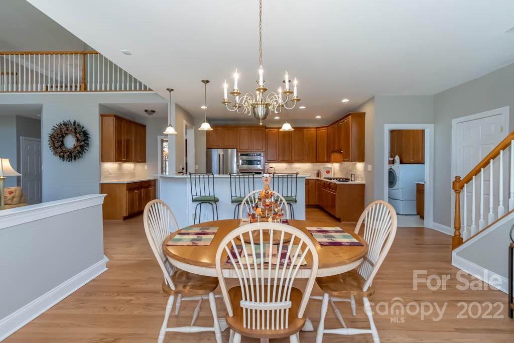 1629 Stevens Ridge Road Matthews, NC 28105 - Photo 20 of 39 a view of a dining room with furniture wooden floor and chandelier