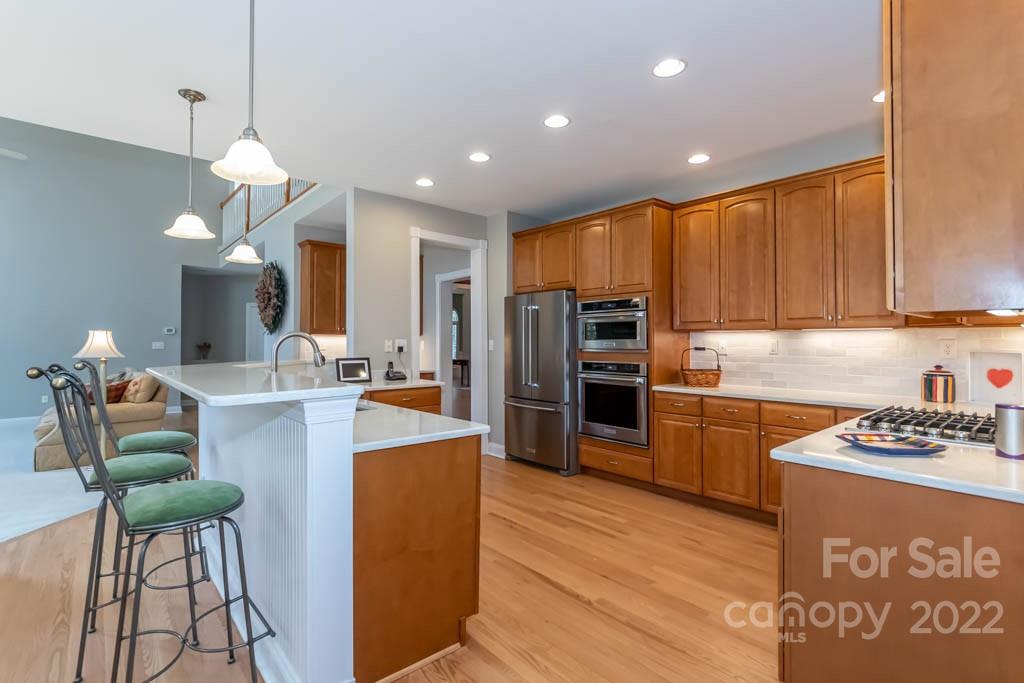 1629 Stevens Ridge Road Matthews, NC 28105 - Photo 21 of 39 a kitchen with stainless steel appliances kitchen island granite countertop a refrigerator and a stove top oven