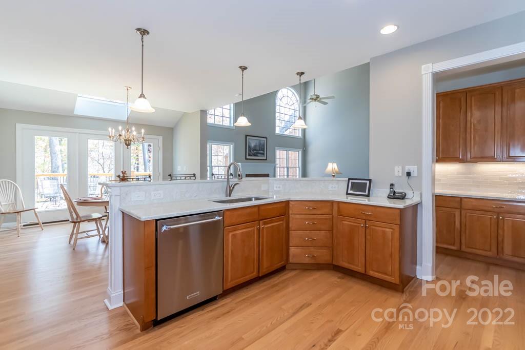 1629 Stevens Ridge Road Matthews, NC 28105 - Photo 23 of 39 a large kitchen with kitchen island a sink a stove a dining table and chairs