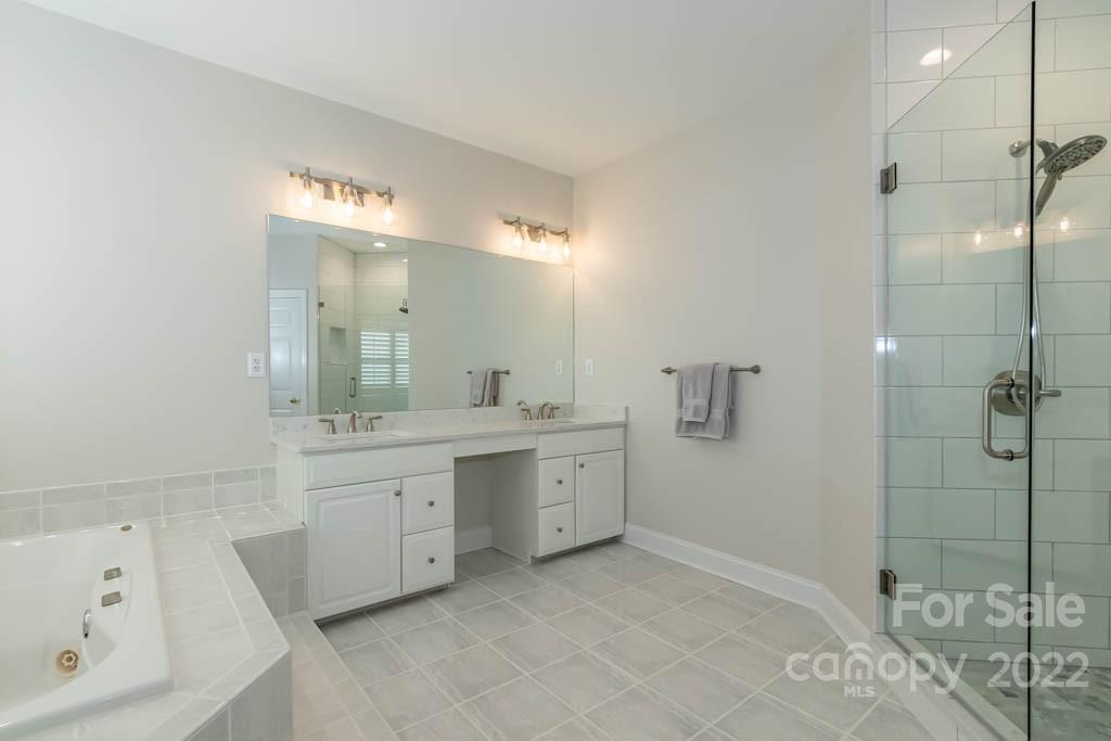 1629 Stevens Ridge Road Matthews, NC 28105 - Photo 27 of 39 a spacious bathroom with a granite countertop sink a toilet and shower