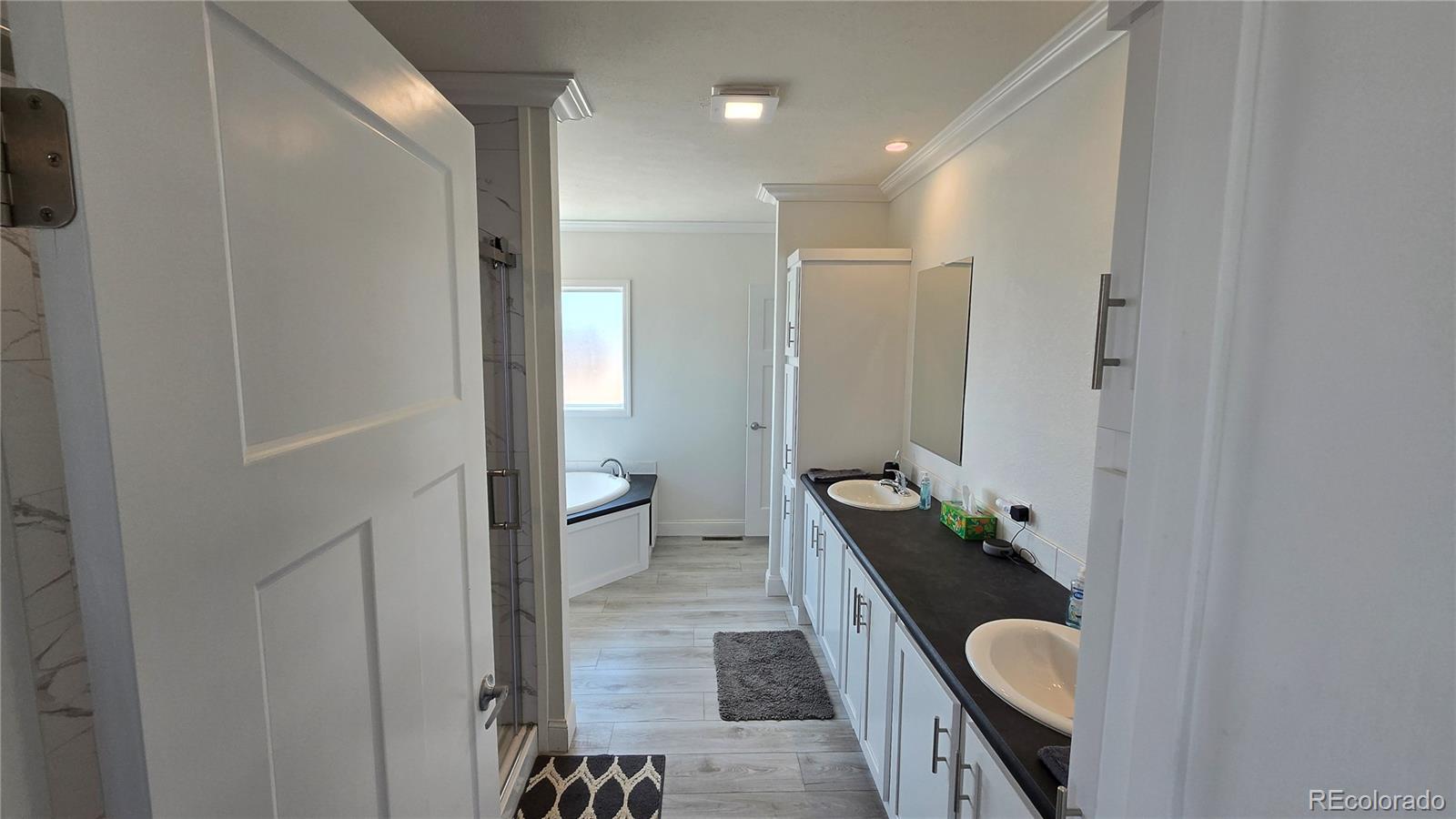 16383 Peacock Road Sanford, CO 81151 - Photo 11 of 33 a bathroom with a granite countertop sink a toilet and shower