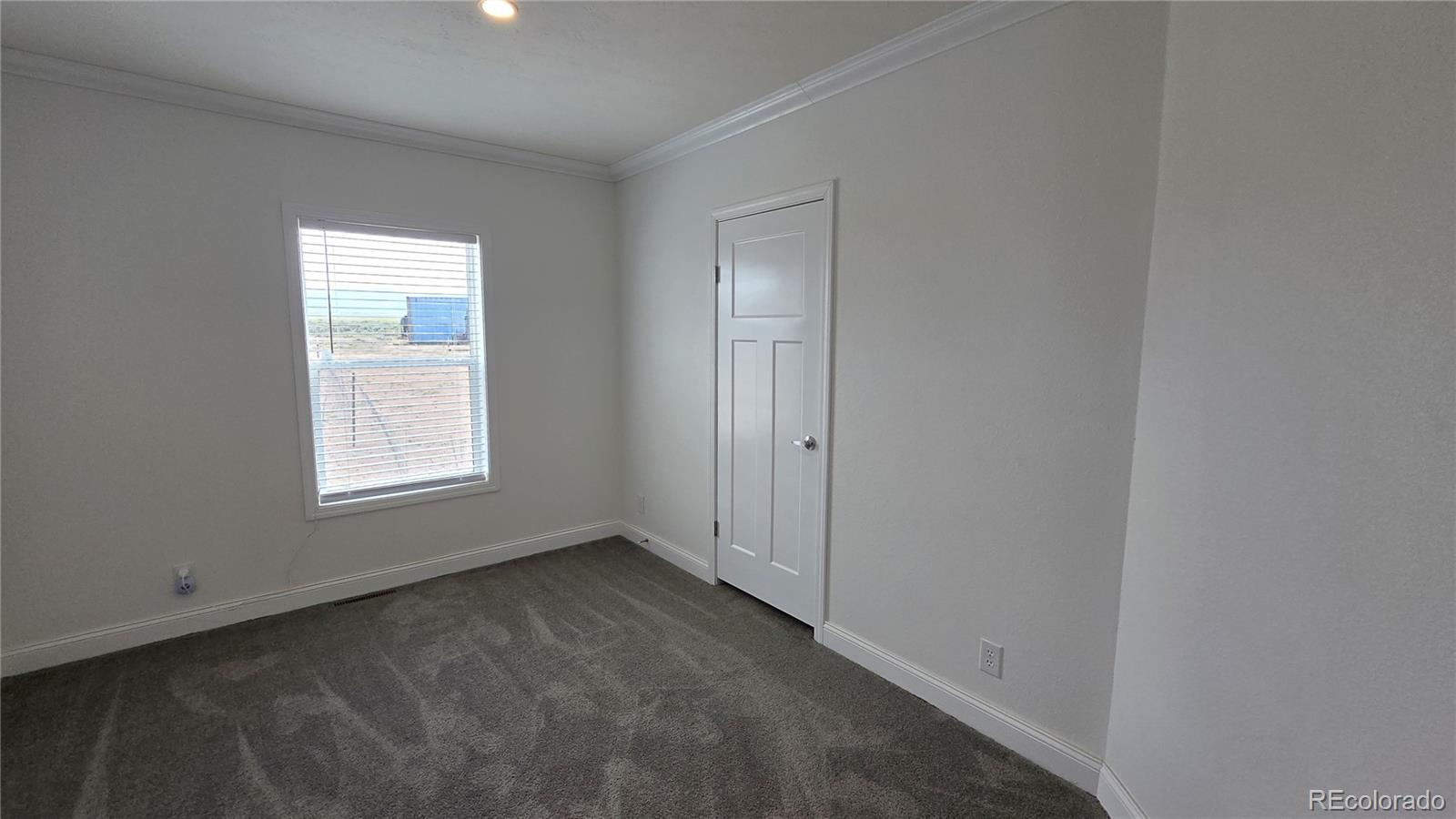 16383 Peacock Road Sanford, CO 81151 - Photo 19 of 33 a view of an empty room with a window