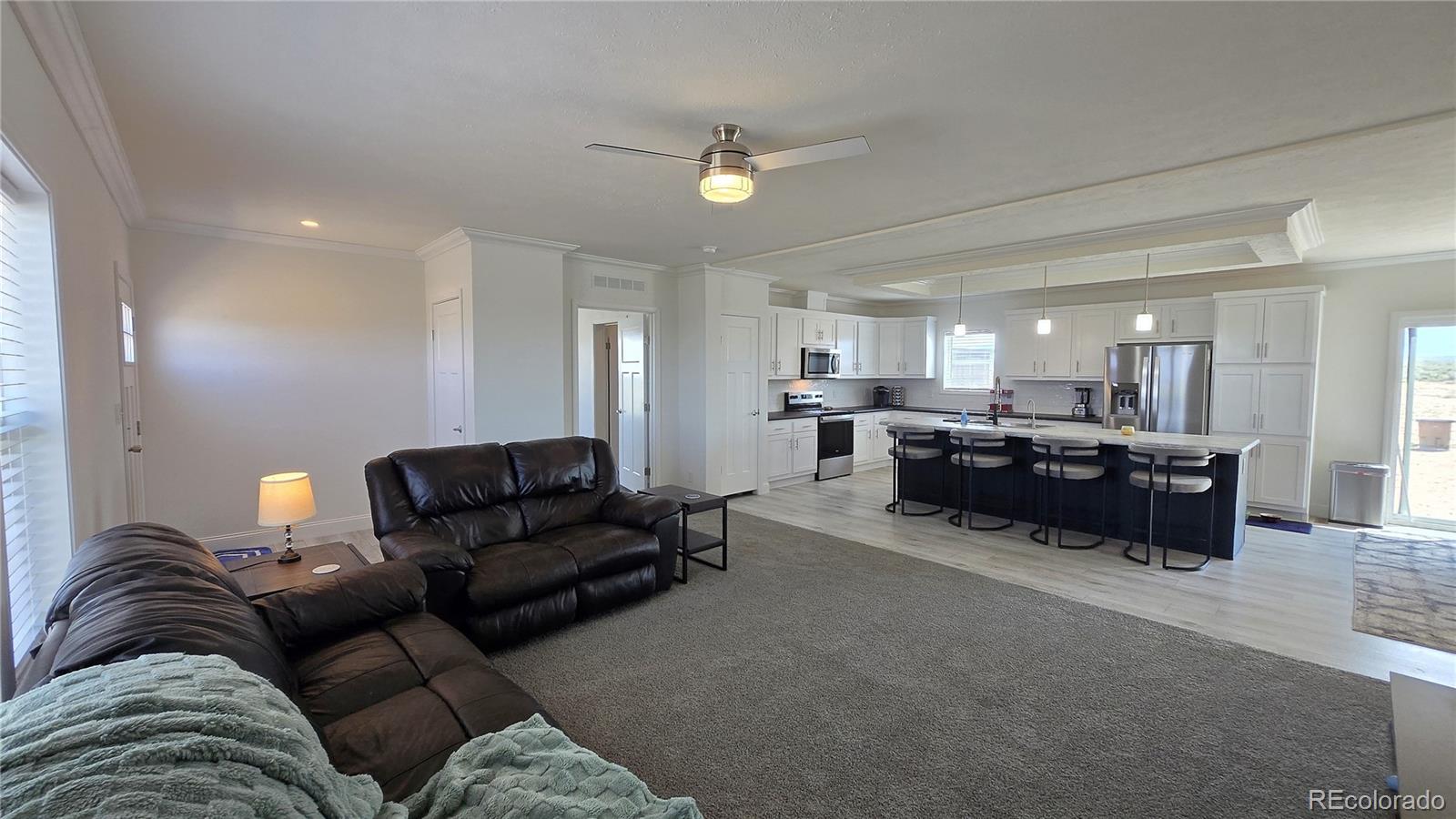 16383 Peacock Road Sanford, CO 81151 - Photo 2 of 33 a living room with furniture and a couch