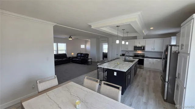 a kitchen with a refrigerator a sink and a stove top oven