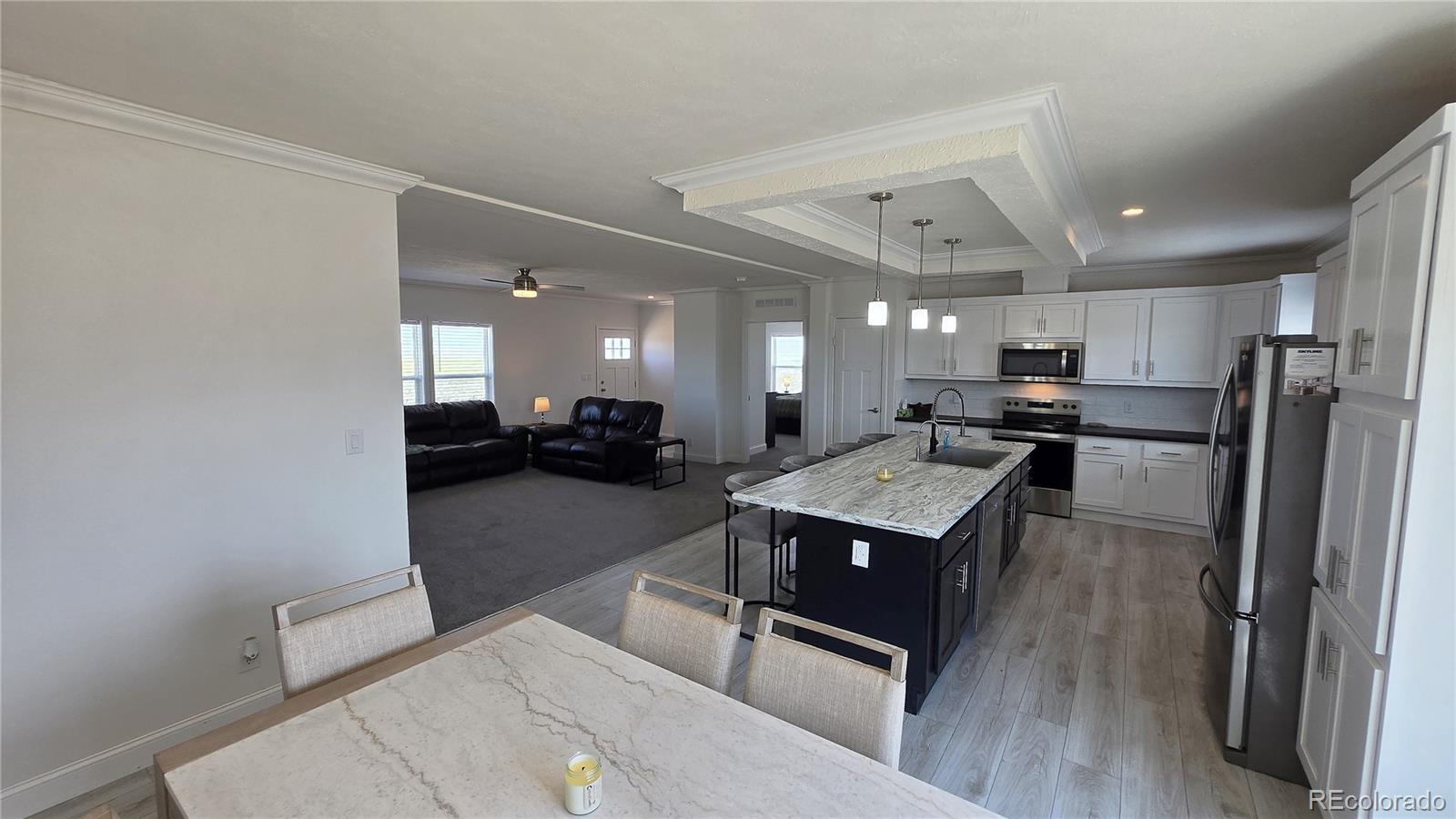 16383 Peacock Road Sanford, CO 81151 - Photo 7 of 33 a kitchen with a refrigerator a sink and a stove top oven