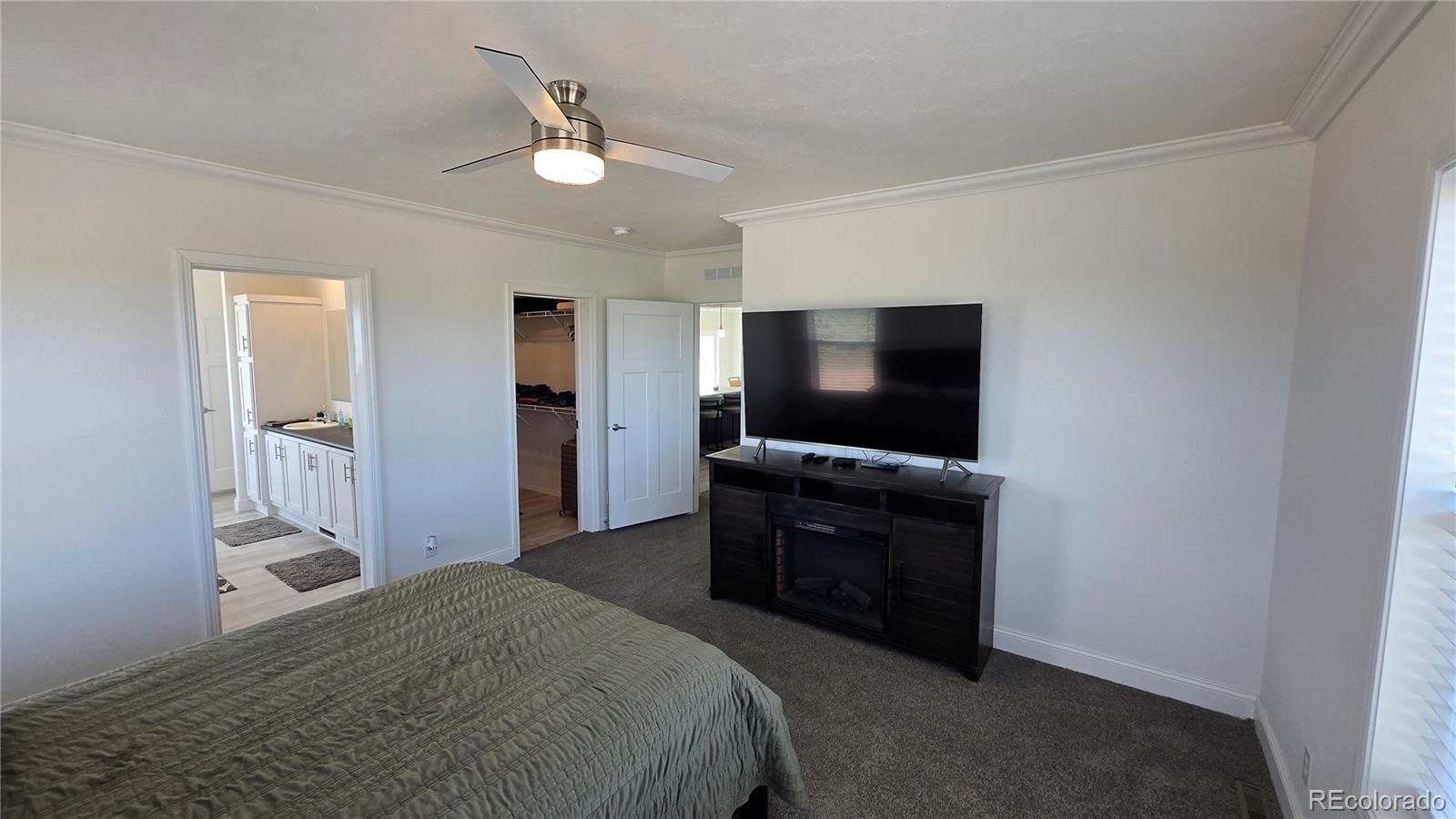 16383 Peacock Road Sanford, CO 81151 - Photo 10 of 33 a bedroom with a bed and a flat screen tv