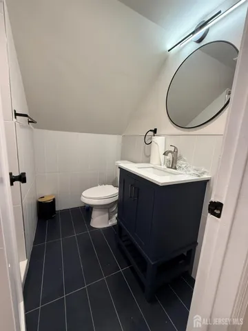 a bathroom with a sink toilet and a mirror