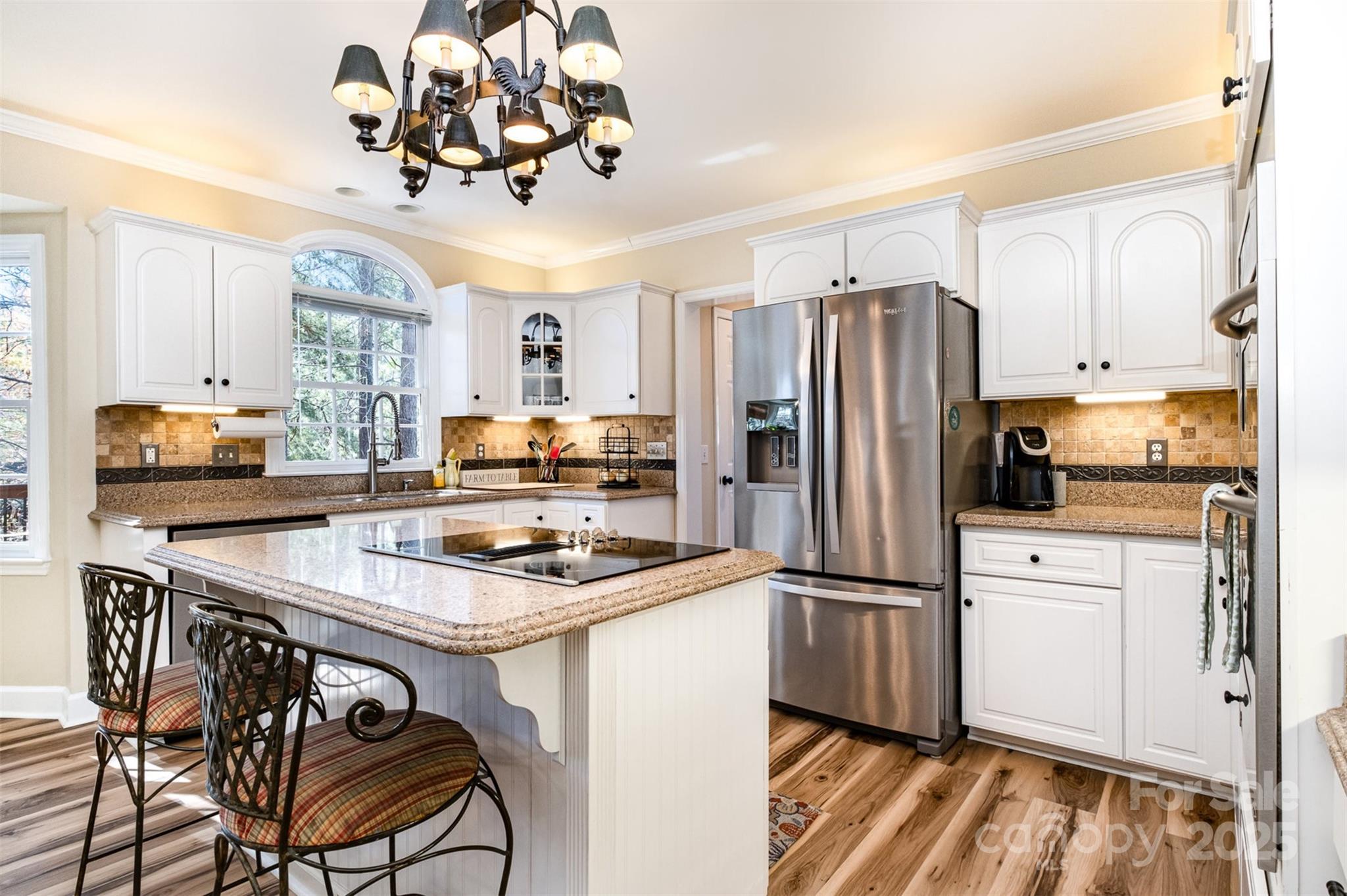 11122 Windgate Court Tega Cay, SC 29708 - Photo 10 of 48 a kitchen with a refrigerator a stove a sink and chairs
