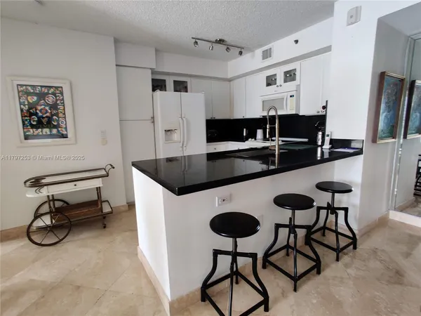 a kitchen with stainless steel appliances a sink and a refrigerator
