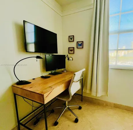 a workspace with furniture and window