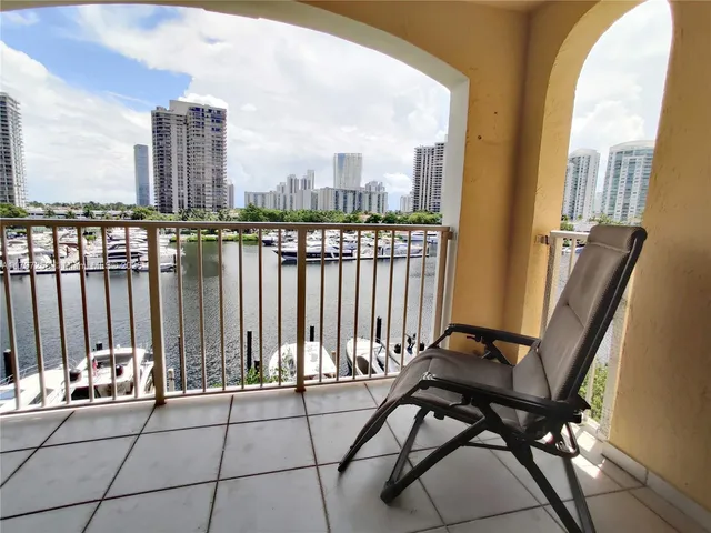 a view of balcony with two chairs and a rug