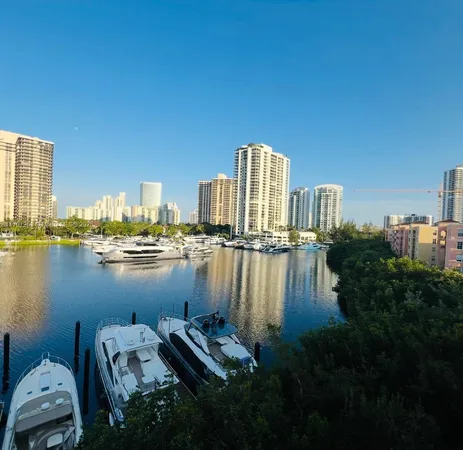 a view of water with boats and trees in the background