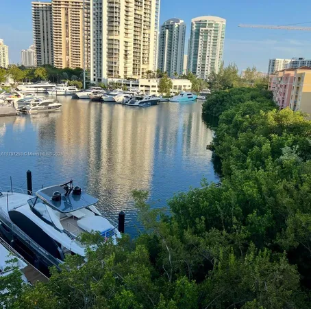 a view of a lake with a building and outdoor seating