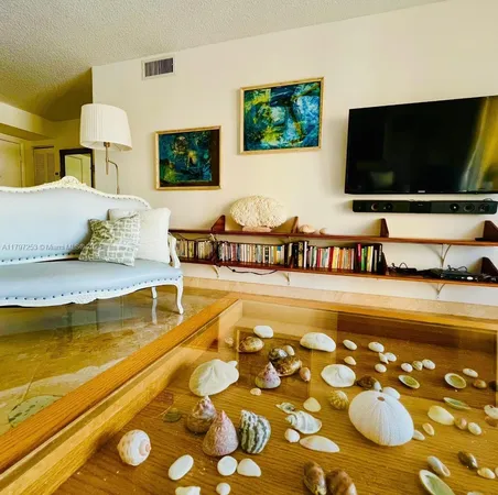 a living room with hard wood floor and a flat screen tv