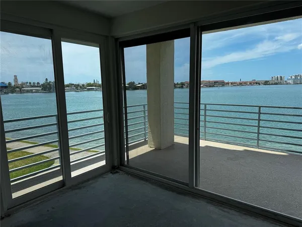 a view of a balcony with floor to ceiling window next to a road