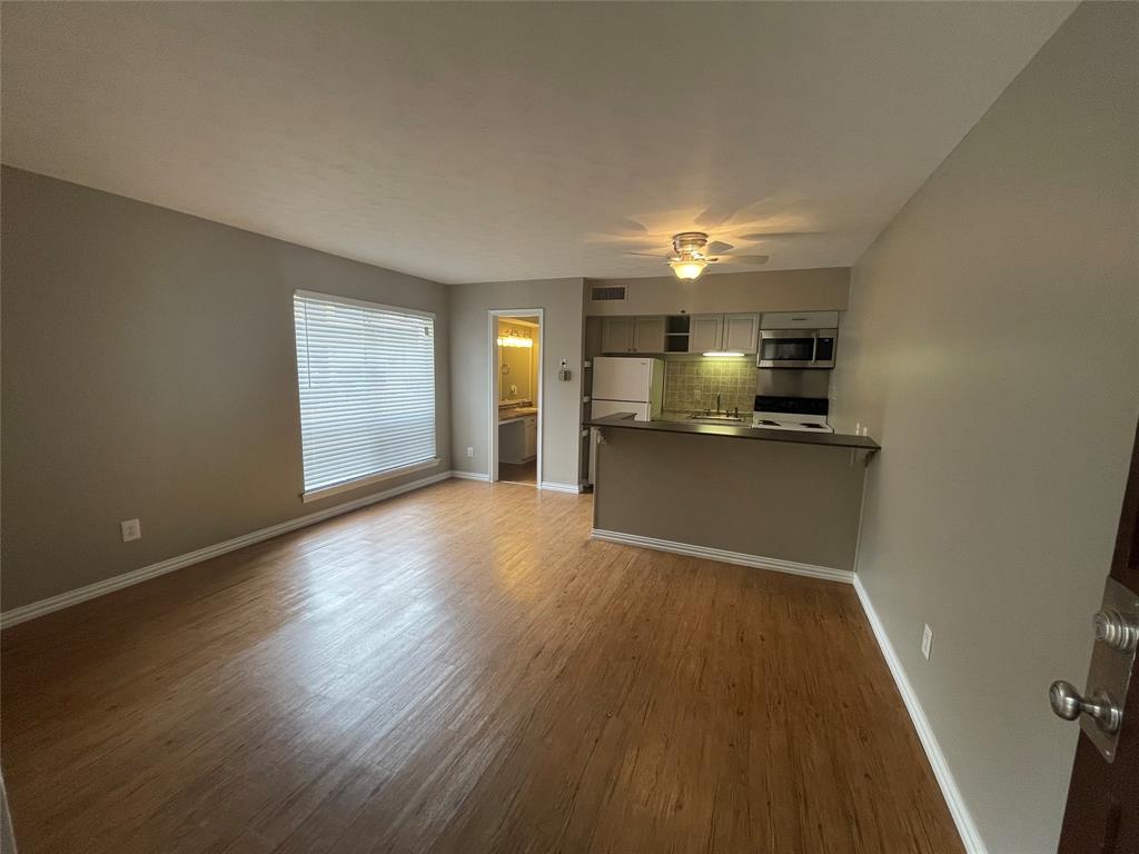 5010 Bowser Avenue, Unit 107 Dallas, TX 75209 - Photo 1 of 1 a view of a kitchen with a sink stove cabinets and empty room