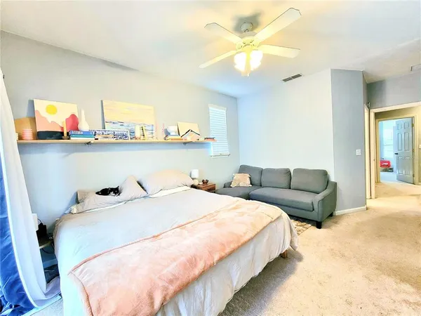a bedroom with a bed and ceiling fan