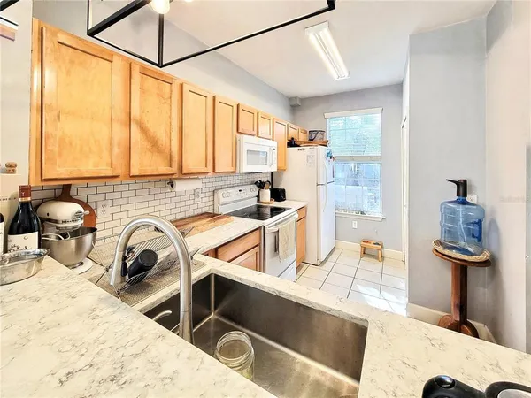 a kitchen with a refrigerator and a sink