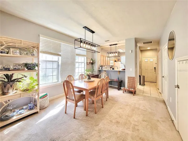 a dining room with furniture and a floor to ceiling window