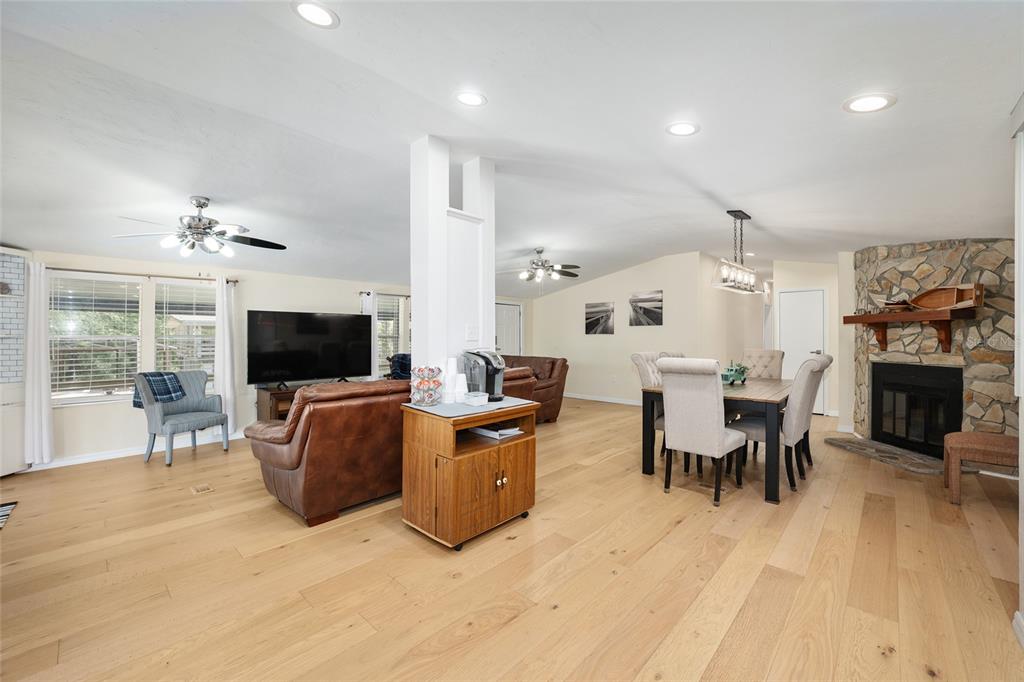 7870 Southwest 25th Place Bell, FL 32619 - Photo 77 of 99 a living room with furniture a flat screen tv and kitchen view