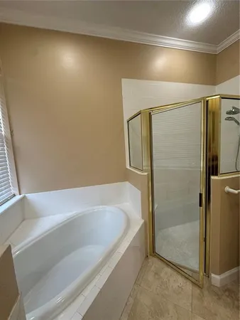 a bathroom with a bathtub and a shower