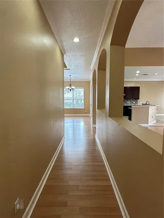 a view of a hallway with wooden floor