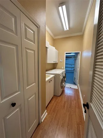 a kitchen with a refrigerator a sink and wooden floor