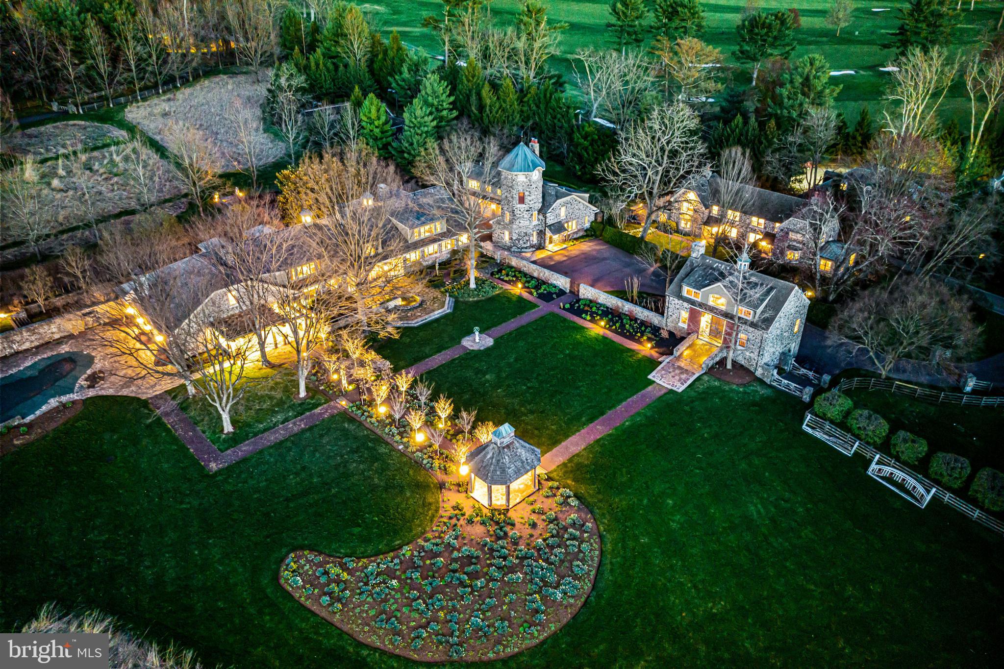 770 Godfrey Road Villanova, PA 19085 - Photo 1 of 150 an aerial view of a house with a garden and lake view