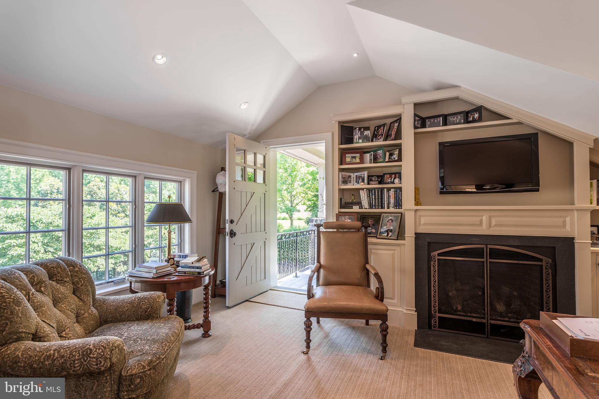 770 Godfrey Road Villanova, PA 19085 - Photo 90 of 150 a living room with furniture a fireplace and a flat screen tv