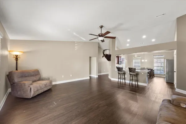 a living room with furniture and wooden floor