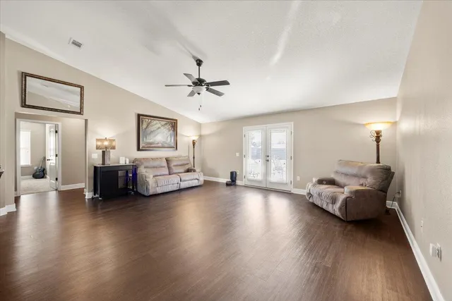 a living room with furniture and wooden floor