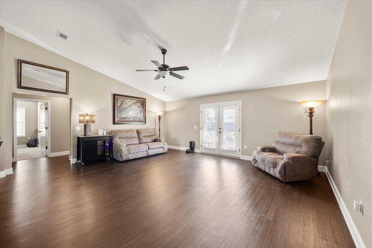 5755 Stream Mill Way Pace, FL 32571 - Photo 13 of 29 a living room with furniture and wooden floor