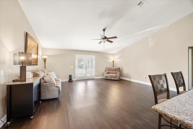 a living room with furniture and wooden floor